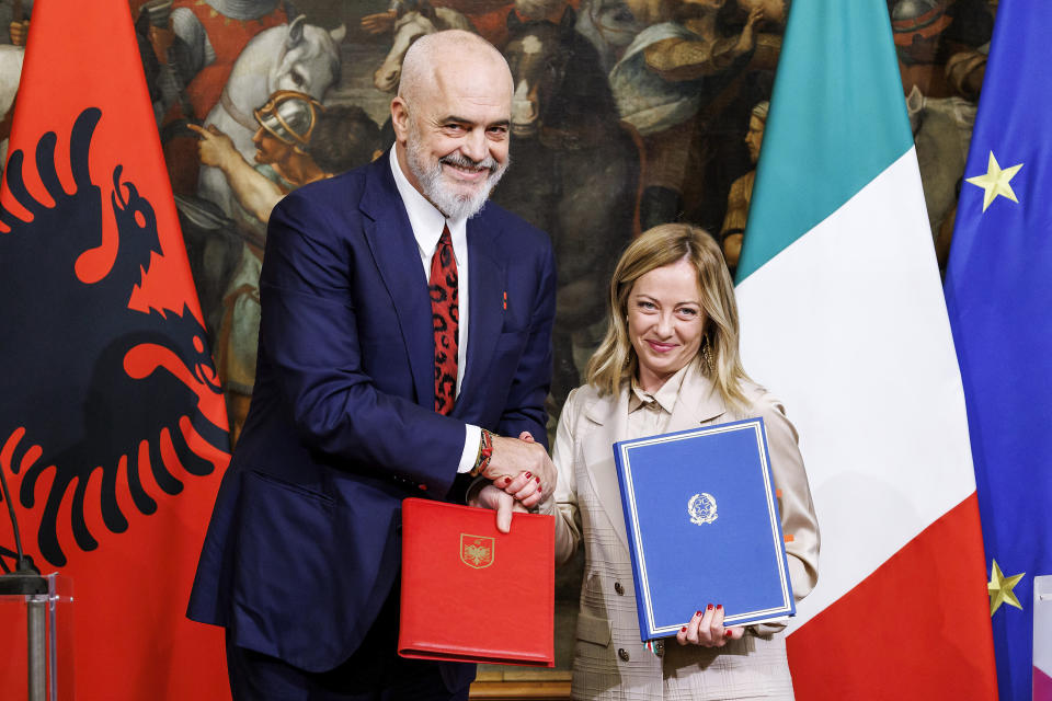 FILE - Italy's Prime Minister Giorgia Meloni, right, and his Albanian counterpart Edi Rama shake hands after the signing of a memorandum of understanding on migrant management centers during a meeting in Rome, Italy, Monday Nov. 6, 2023. Albania's Assembly, or Parliament, votes on Thursday, Feb. 22, 2024, and is expected to approve a deal with Italy under which thousands of migrants rescued at sea by Italian authorities would be sent to Albania while their applications for asylum in Italy are processed. (Roberto Monaldo/LaPresse via AP, File)