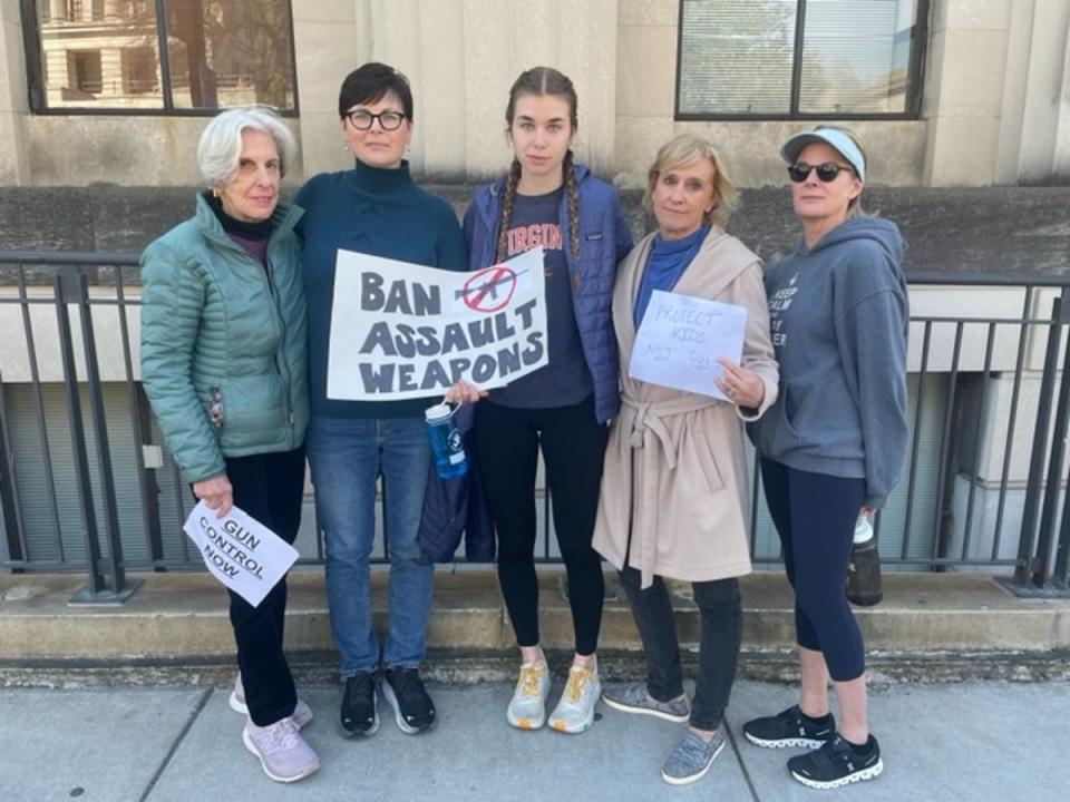 Linda Herrell, 45, holds a ‘BAN ASSAULT WEAPONS’ sign as she stands next to her 17-year-old daughter, Eleanor, and friends after a Thursday rally at the Tennessee State Capitol (Sheila Flynn)