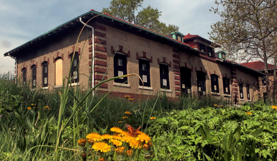 FILE - This May 8, 2009, file photo shows Ellis Island's boarded up hospital for contagious disease ward, which opened in 1909 as part of the island's main hospital complex. The National Trust for Historic Preservation has released its annual list of America's 11 Most Endangered Historic places. In the past 25 years, the non-profit organization has listed 234 sites. New York State has made the list 18 times. This section of Ellis Island, where 29 neglected hospital and support buildings are located, has been cited three times, including this year. (AP Photo/Bebeto Matthews, File)