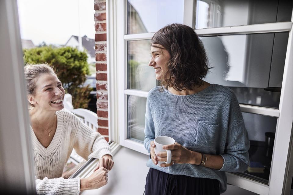 two woman talking in doorway