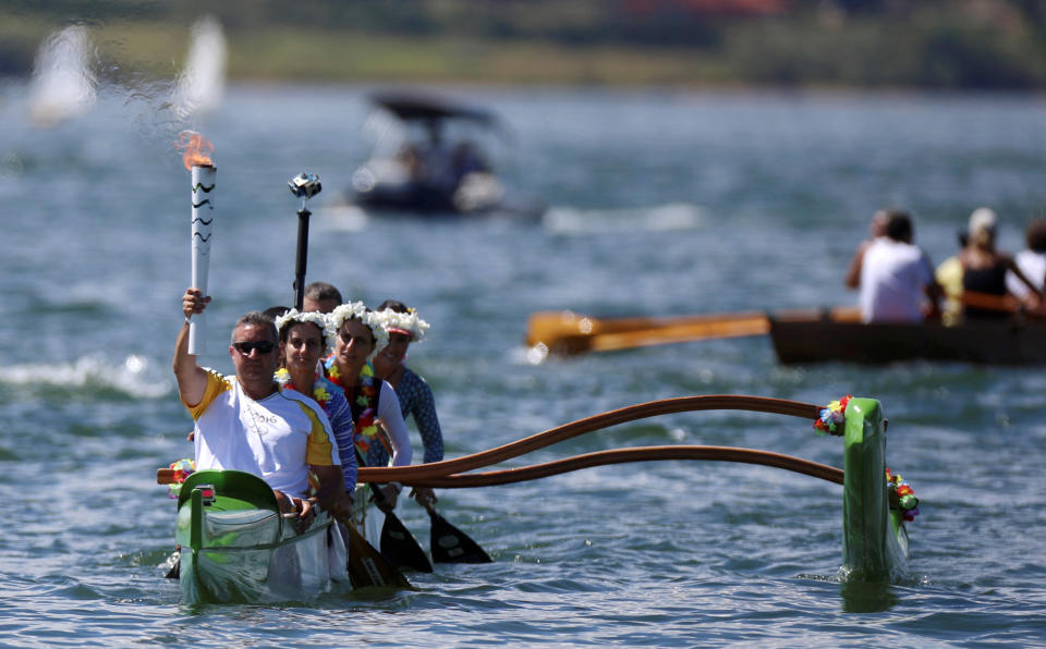 Canoeist Rubens Pompeu takes part in the Olympic Flame torch relay at Paranoa lake in Brasilia, Brazil, May 3, 2016. REUTERS/Adriano Machado