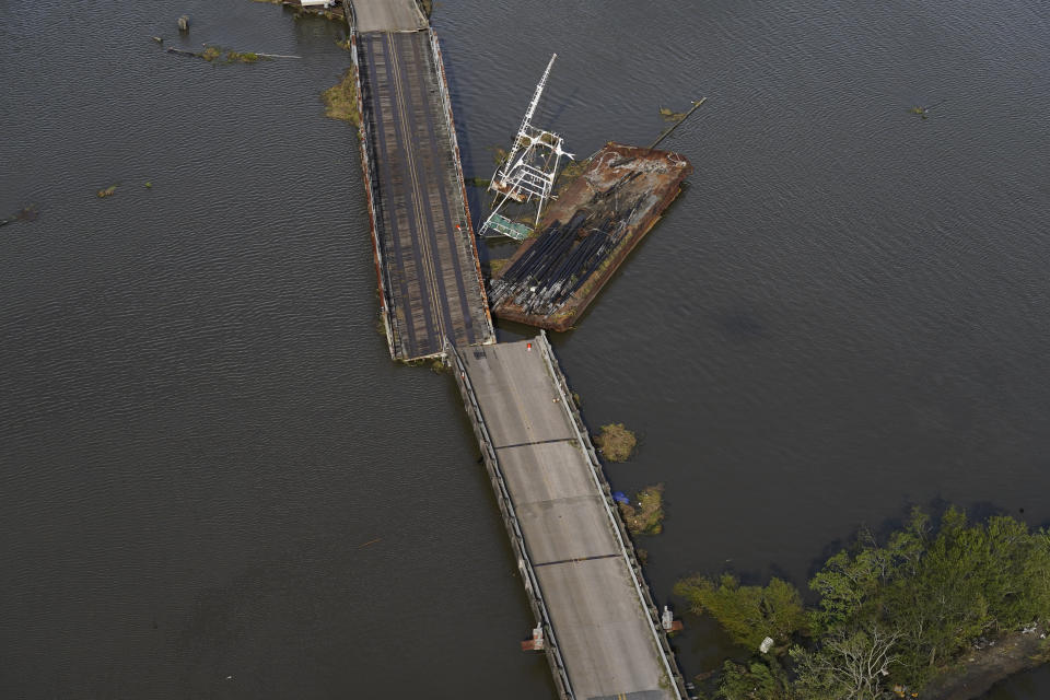 A barge damages a bridge that divides Lafitte, La., and Jean Lafitte, in the aftermath of Hurricane Ida, Monday, Aug. 30, 2021, in Lafitte, La. (AP Photo/David J. Phillip)