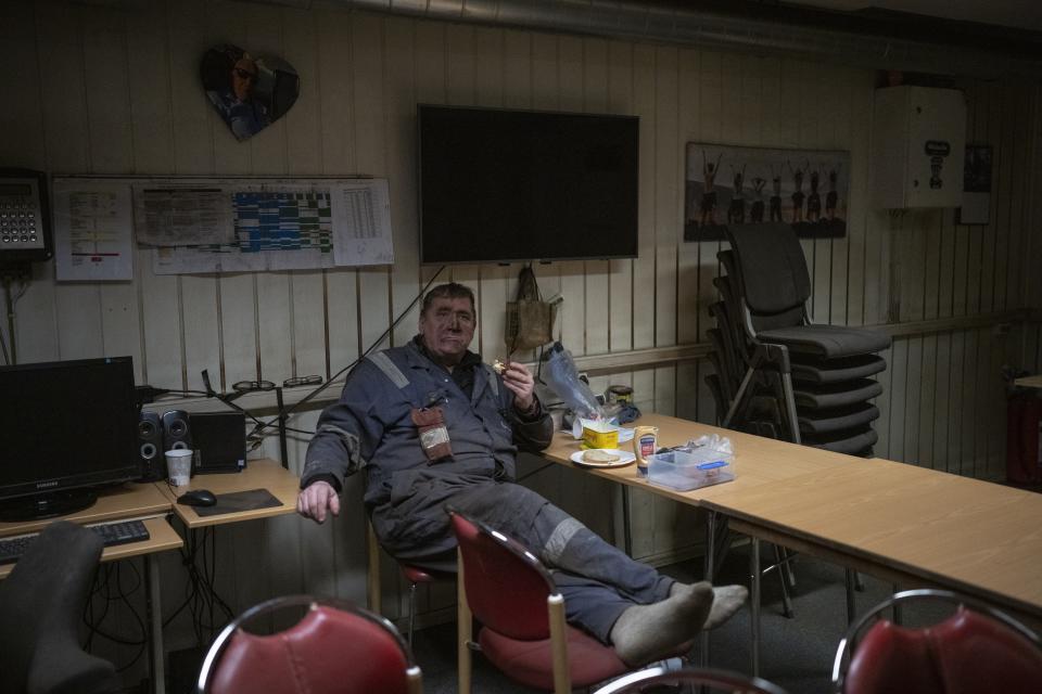 A coal miner rests in the break room at the bottom of the Gruve 7 coal mine in Adventdalen, Norway, Monday, Jan. 9, 2023. The last Norwegian coal mine in Svalbard – an archipelago that's one of the world's fastest warming spots – was slated to close this year and only got a reprieve until 2025 because of the energy crisis driven by the war in Ukraine. (AP Photo/Daniel Cole)