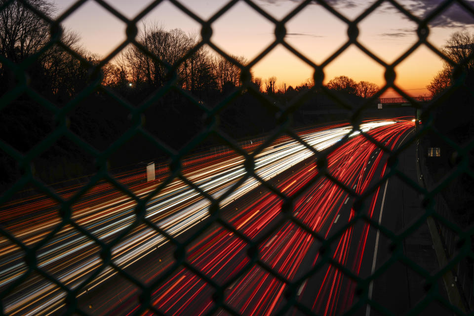 In this long exposure photo, motor vehicles move along Interstate 276 in Feasterville, Pa., Thursday, Dec. 21, 2023. (AP Photo/Matt Rourke)