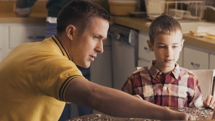 A father interacts with his son in First Man.