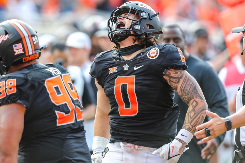 Oklahoma State’s Mason Cobb (0) celebrates after intercepting a pass in the third quarter during a college football game between the Oklahoma State Cowboys and the Texas Tech Red Raiders at Boone Pickens Stadium in Stillwater, Okla., Saturday, Oct. 8, 2022. OSU won 41-31.