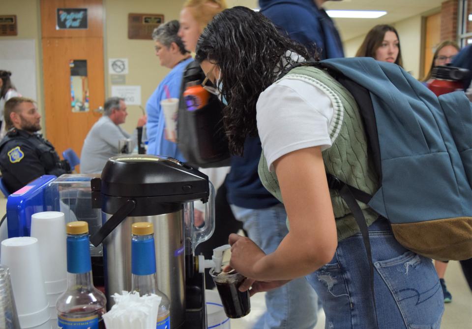 Lailene Conde, a junior at Lincoln High School, fills a cup with iced coffee at the RISE coffee stand on May 20, 2022.