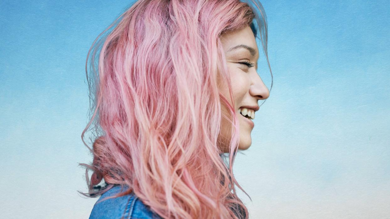 best-products-for-color-treated-hair: woman with pink hair laughing