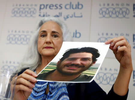 Debra Tice, the mother of American journalist Austin Tice, holds his picture during a news conference in Beirut, Lebanon July 20, 2017. REUTERS/Jamal Saidi