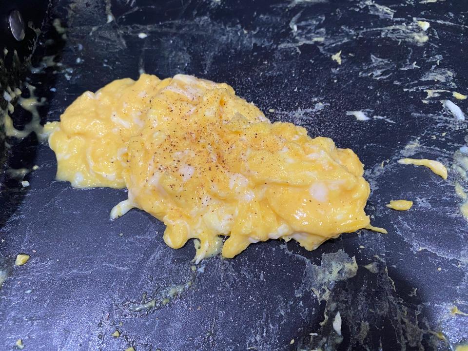 scrambled eggs with seltzer water cooking in a pan