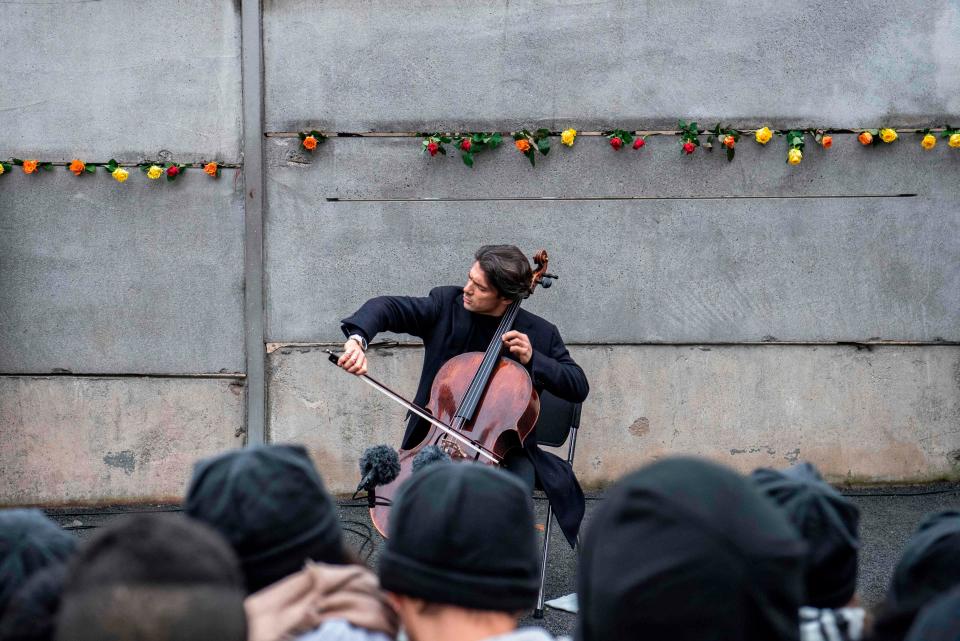 French cellist Gautier Capucon performs at the Berlin Wall memorial after official guests attended celebrations of the 30th anniversary of the fall of the Berlin Wall, on Nov. 9, 2019 in Bernauer Strasse in Berlin.