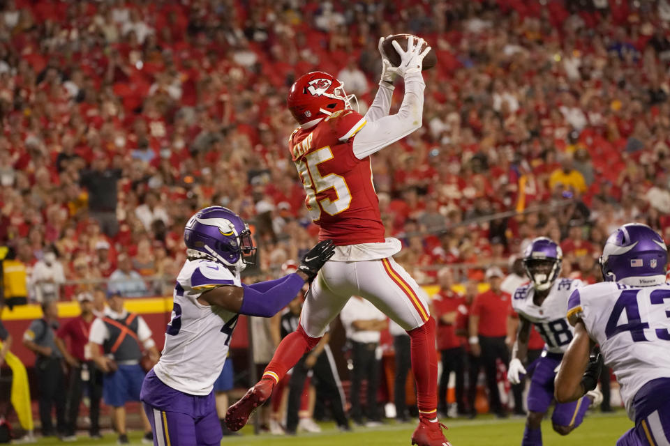 Kansas City Chiefs wide receiver Marcus Kemp (85) catches a touchdown pass as Minnesota Vikings safety Myles Dorn, left, defends during the first half of an NFL football game Friday, Aug. 27, 2021, in Kansas City, Mo. (AP Photo/Charlie Riedel)