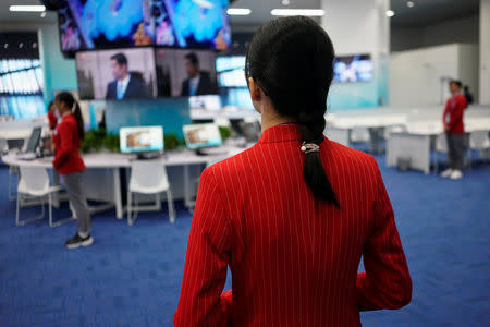 A volunteer stands at the National Exhibition and Convention Center, the venue for the upcoming China International Import Expo (CIIE), in Shanghai, China November 3, 2018. REUTERS/Aly Song