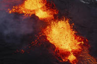 A close up of the Southern active segment of the original fissure of an active volcano in Grindavik on Iceland's Reykjanes Peninsula, Tuesday, Dec. 19, 2023. (AP Photo/Marco Di Marco)