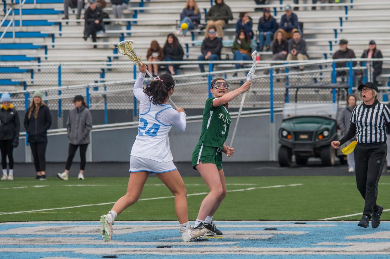 South Burlington's Sabina Brunet wins the draw from Rice's Violet Clough during the Wolves' 13-5 win over the Green Knights on Thursday afternoon in South Burlington.