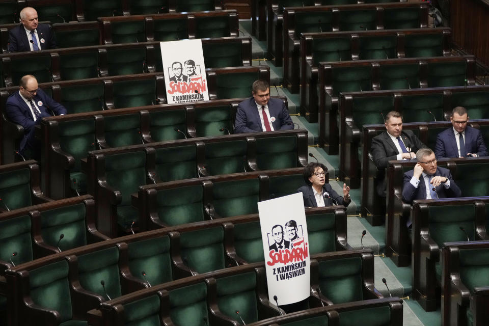 Posters with images of imprisoned members of Poland's previous right-wing government, former interior minister, Mariusz Kaminski and former deputy interior minister, Maciej Wasik, who have been convicted of abuse of power, displayed in the opposition section of the lower chamber of Poland's parliament during session, in Warsaw, Poland, Tuesday Jan.16, 2024. The previously governing Law and Justice party, now in the opposition, are protesting the imprisonment and say the two are "political prisoners." (AP Photo/Czarek Sokolowski)