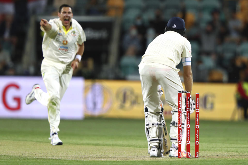 England's Joe Root, right, is bowled by Australia's Scott Boland during their Ashes cricket test match in Hobart, Australia, Sunday, Jan. 16, 2022. (AP Photo/Tertius Pickard)