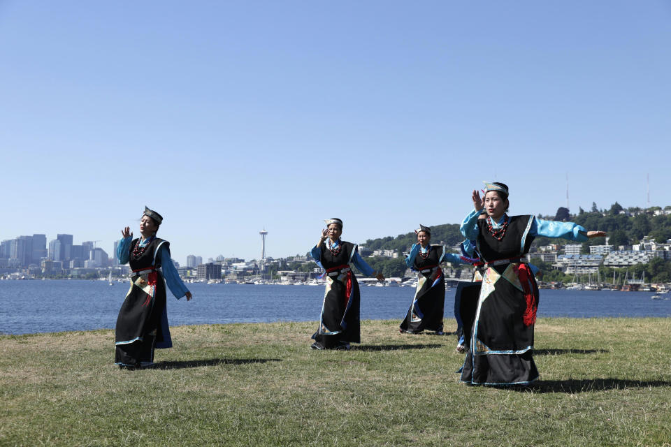 Members of a Seattle Tibetan Choelsum Bhumo dance group record a video for an upcoming virtual festival in the morning during a heat wave hitting the Pacific Northwest, Sunday, June 27, 2021, in Seattle. Yesterday set a record high for the day with more record highs expected today and Monday. (AP Photo/John Froschauer)