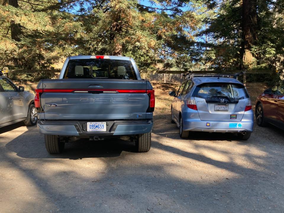 The Ford F-150 Lightning next to a Honda Fit.