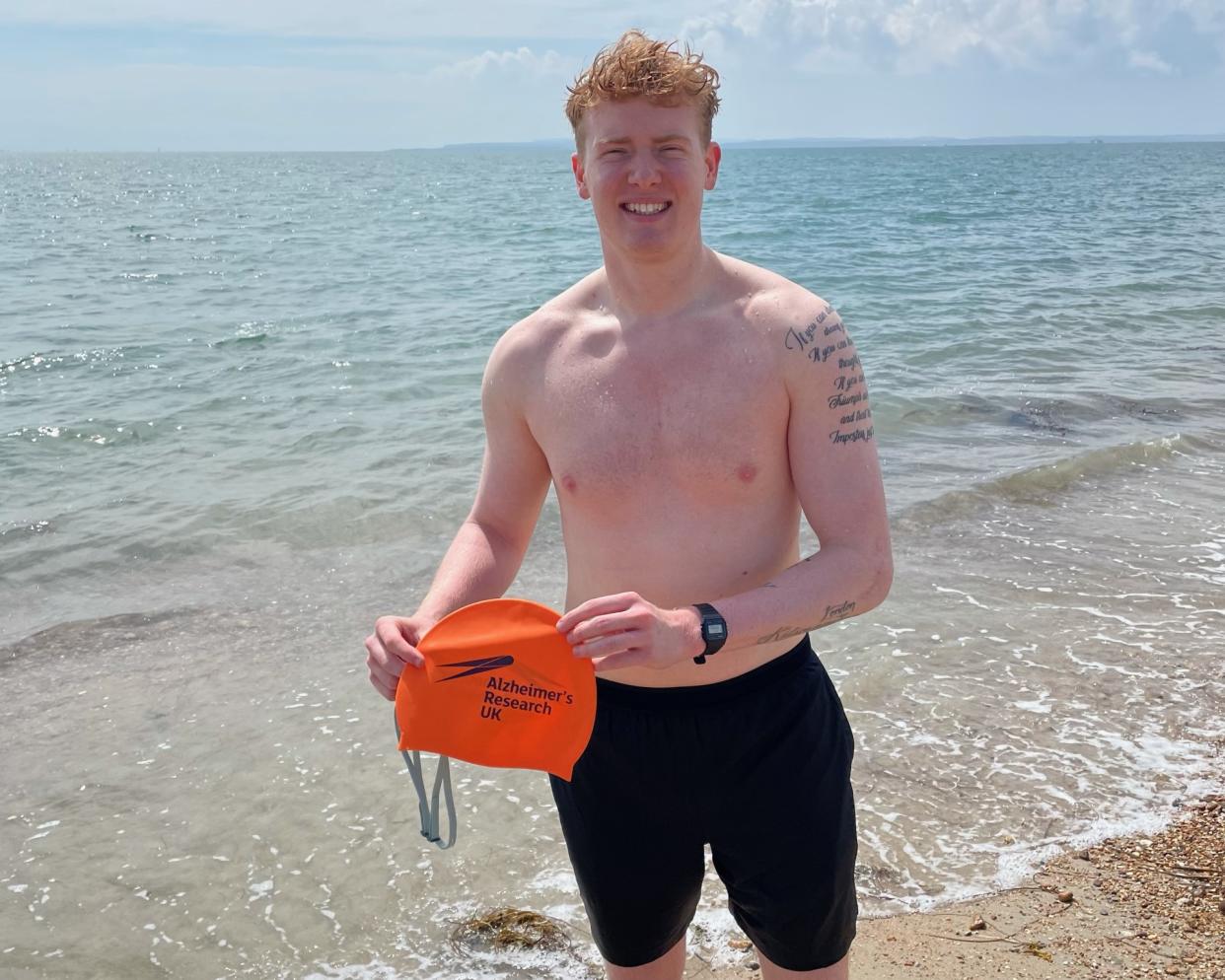 Man with swimming shorts and a hat