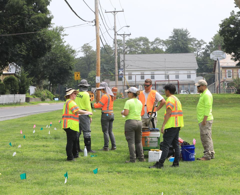 An environmental survey crew working for Verizon in the midst of a preliminary study checking to see if telephone transmission lines have caused lead contamination near Temple Park in the Village of Wappingers Falls on July 18, 2023. Through an abundance of safety, the village has closed Temple Park until Verizon can determine if there is lead contamination. 