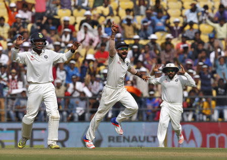 India's captain Virat Kohli (C) along with his teammates Cheteshwar Pujara (L) and Rohit Sharma appeal unsuccessfully for the wicket of South Africa's Faf du Plessis during the third day of their third test cricket match in Nagpur, India, November 27, 2015. REUTERS/Amit Dave