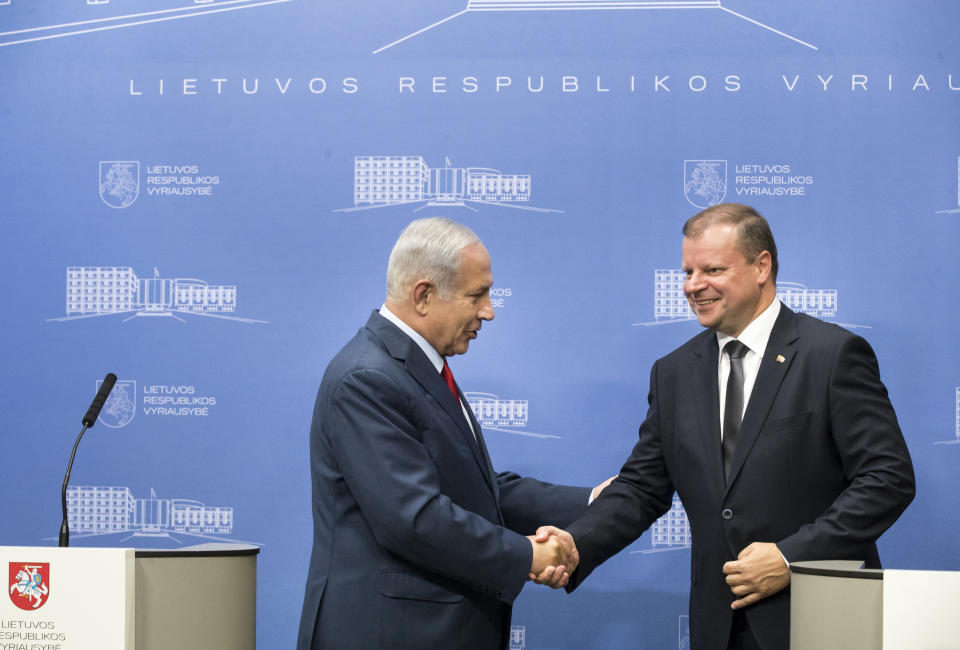 Lithuania's Prime Minister Saulius Skvernelis, right, and Israel's Prime Minister Benjamin Netanyahu shake hands at the end of a news conference at the government's headquarters in Vilnius, Lithuania, Thursday, Aug. 23, 2018. (AP Photo/Mindaugas Kulbis)