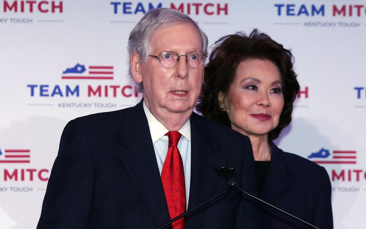 Mitch McConnell is joined by his wife, Elaine Chao, as he speaks at a press conference in Kentucky - Mark Lyons/Shutterstock