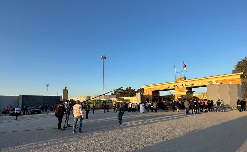 People stand near the Rafah border crossing with Gaza strip, in Rafah