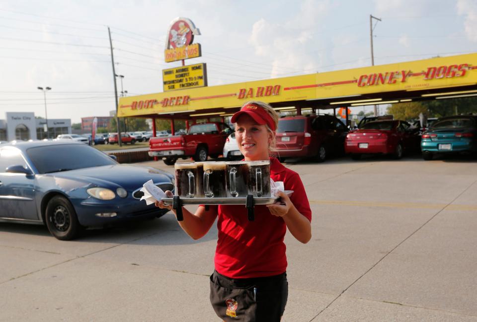 A carhop delivers an order at a Dog n Suds in Lafayette, Ind., in 2015.