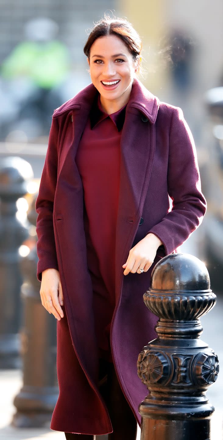 <p>Meghan was spotted in a similar burgundy coat and dress while visiting the Hubb Community Kitchen in 2018. Such a nice color on her. </p>