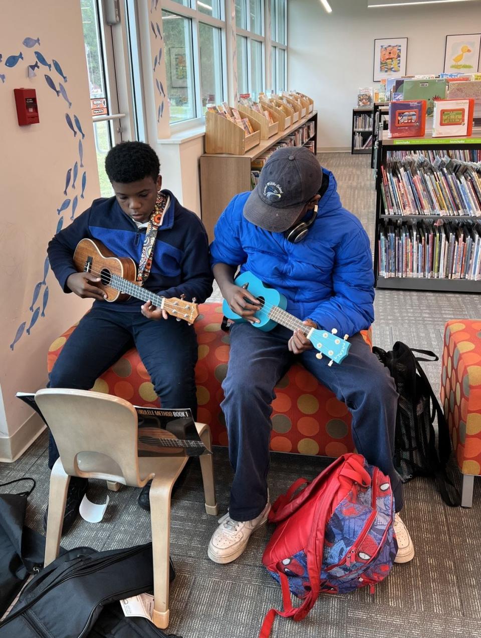 Two students check out ukuleles for an informal afternoon of playing music together at Southwest Chatham Library.