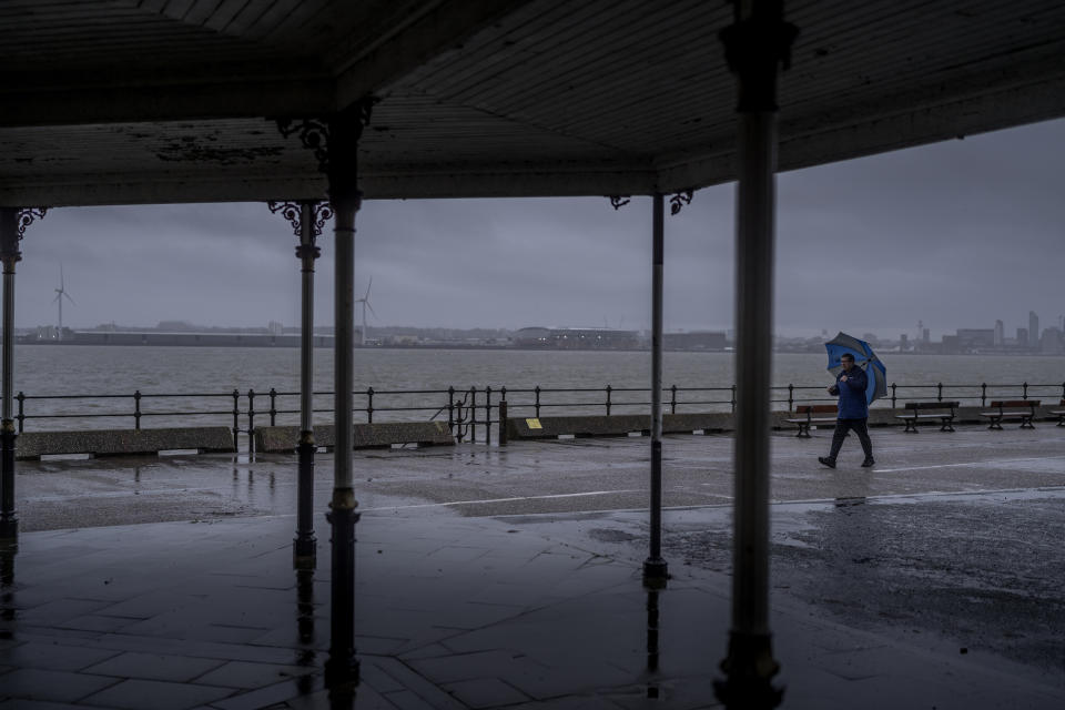 NEW BRIGHTON, UNITED KINGDOM - JANUARY 23: As Storm Jocelyn approaches the UK people brave the rain and wind as they walk along New Brighton promenade on January 23, 2024 in New Brighton, United Kingdom. Warnings across the country signal potential flooding and transportation disruptions. Storm Isha, which arrived on Sunday, resulted in two fatalities and left thousands of people without power in the UK after bringing heavy rain and winds up to 99mph. (Photo by Christopher Furlong/Getty Images)