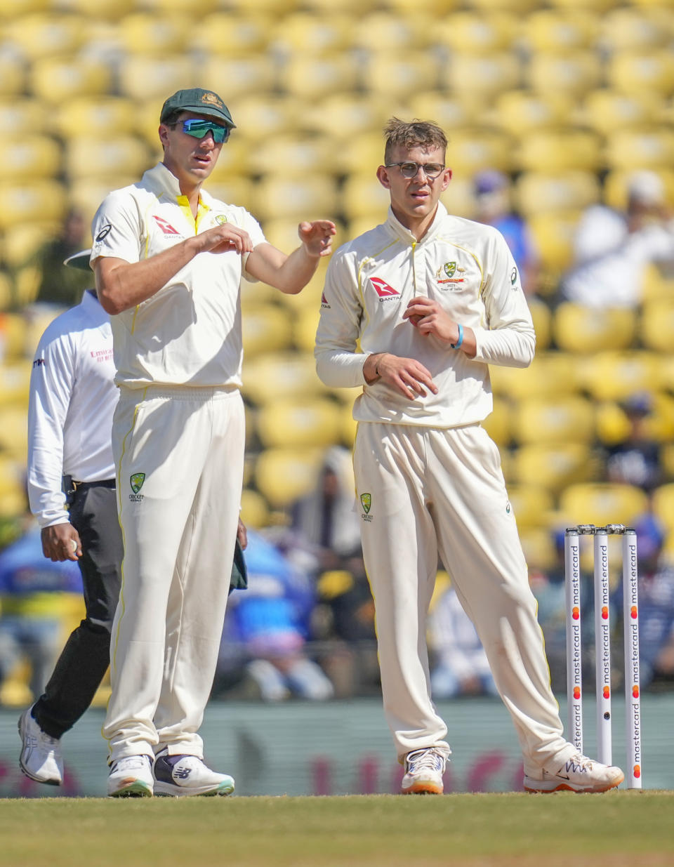 Australia's captain Pat Cummins, left, adjusts fielding as Todd Murphy watches during the third day of the first cricket test match between India and Australia in Nagpur, India, Saturday, Feb. 11, 2023. (AP Photo/Rafiq Maqbool)