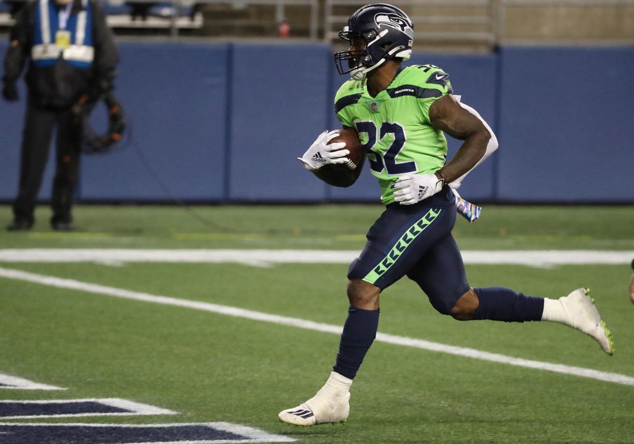 SEATTLE, WASHINGTON - OCTOBER 11: Chris Carson #32 of the Seattle Seahawks  scores a touchdown against the Minnesota Vikings during the third quarter at CenturyLink Field on October 11, 2020 in Seattle, Washington. (Photo by Abbie Parr/Getty Images)