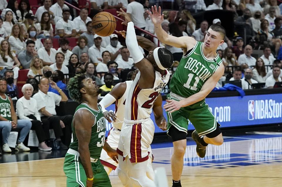 Boston Celtics guard Payton Pritchard (11) fouls Miami Heat forward Jimmy Butler (22) during the first half of Game 2 of the NBA basketball Eastern Conference finals playoff series, Thursday, May 19, 2022, in Miami. (AP Photo/Lynne Sladky)