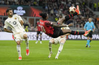 AC Milan's Rafael Leao does an overhead kick during the Europa League quarterfinal first leg soccer match between AC Milan and Roma at the San Siro Stadium, in Milan, Italy, Thursday, April 11, 2024. (AP Photo/Antonio Calanni)