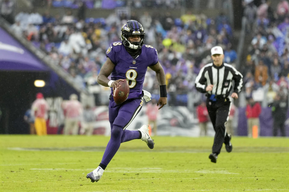 Baltimore Ravens quarterback Lamar Jackson runs with the ball against the Los Angeles Rams during the second half of an NFL football game Sunday, Dec. 10, 2023, in Baltimore. The Ravens won 37-31 in overtime. (AP Photo/Alex Brandon)