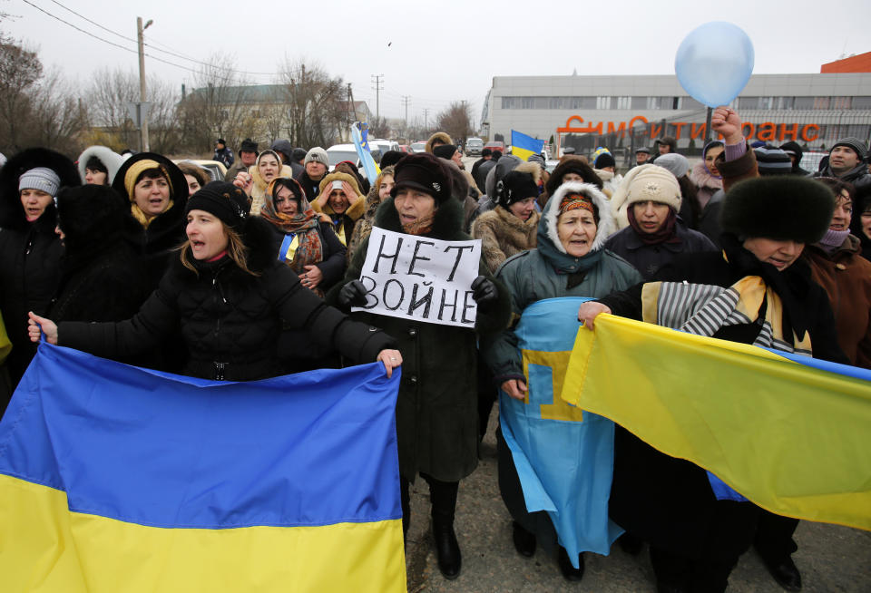 Crimean Tatars shout slogans and hold banner which reads: "No War" during the pro-Ukraine rally in Simferopol, Crimea, Ukraine, Monday, March 10, 2014. Russian President Vladimir Putin on Sunday defended the separatist drive in the disputed Crimean Peninsula as in keeping with international law, but Ukraine's prime minister vowed not to relinquish "a single centimeter" of his country's territory. The local parliament in Crimea has scheduled a referendum for next Sunday. (AP Photo/Darko Vojinovic)