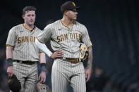 San Diego Padres third baseman Manny Machado, front, and second baseman Jake Cronenworth wait for relief pitcher Nabil Crismatt to take the mound in the eighth inning of the team's baseball game against the Colorado Rockies on Tuesday, June 15, 2021, in Denver. (AP Photo/David Zalubowski)