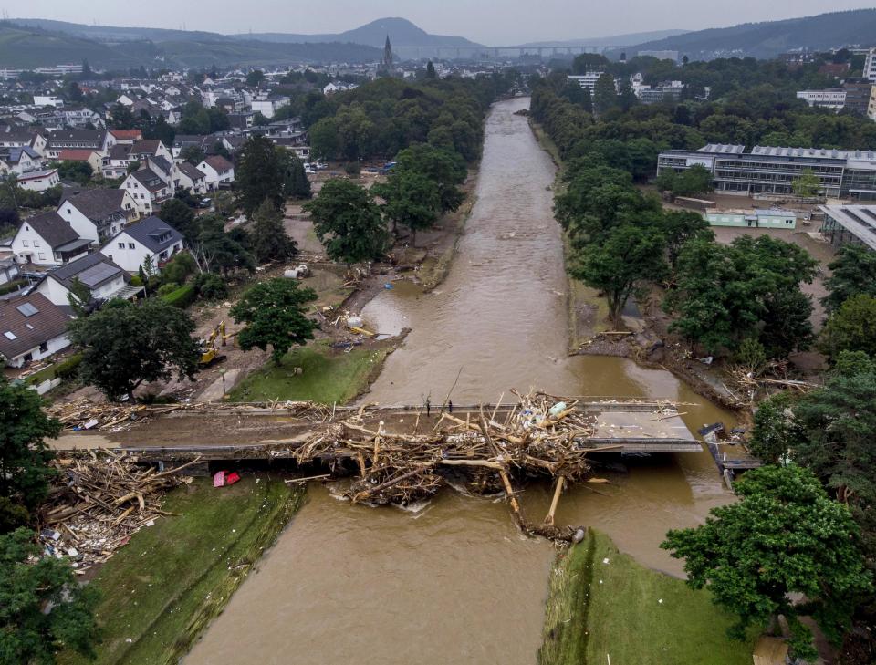 A bridge over the Ahr river is damaged in Bad Neuenahr-Ahrweiler, Germany, Saturday, July 17, 2021. Due to strong rain falls the Ahr river went over the banks and flooded big parts of the town. (AP Photo/Michael Probst)