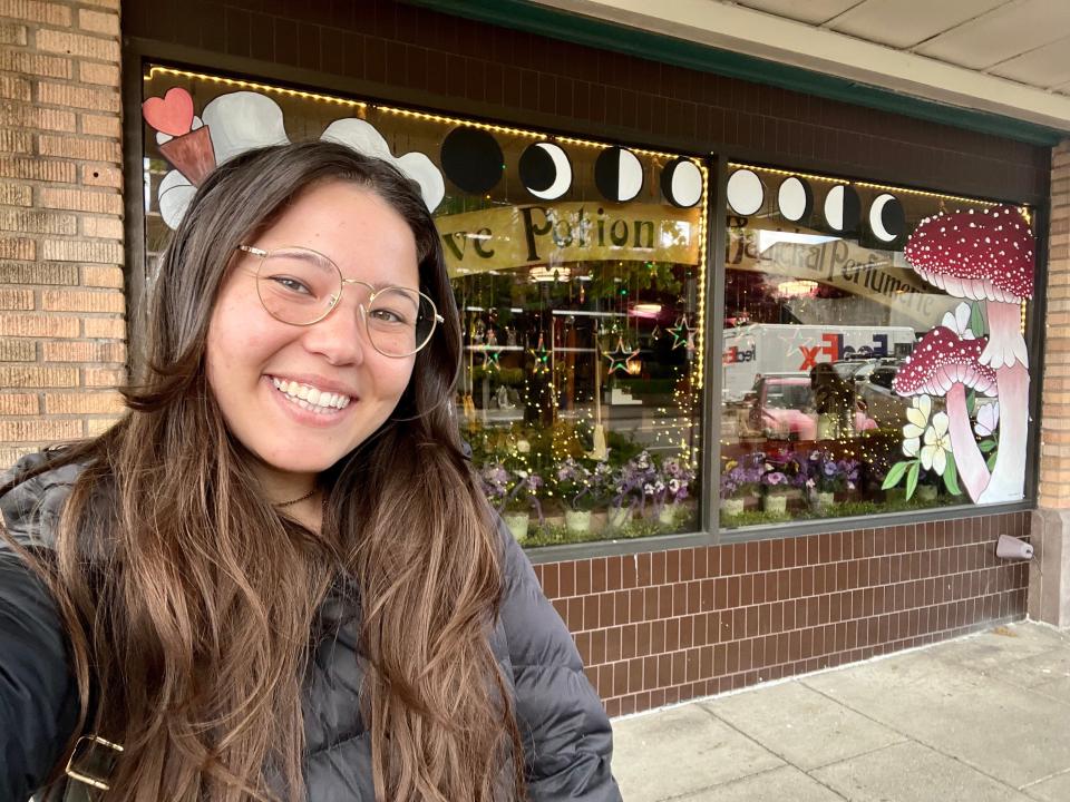 ashley probst smiling in front of potion shop in washington