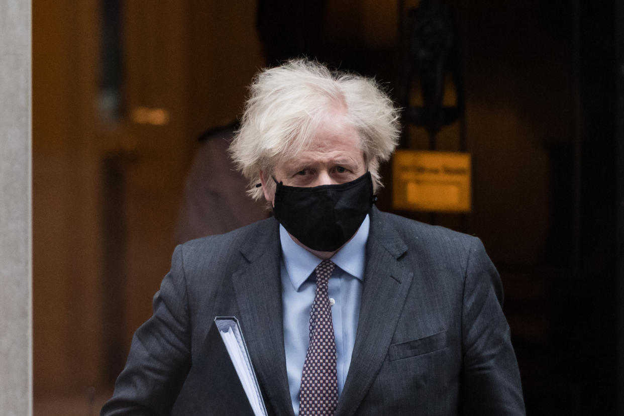 LONDON, UNITED KINGDOM - FEBRUARY 22, 2021: British Prime Minister Boris Johnson leaves 10 Downing Street for the House of Commons to deliver a statement to MPs setting out the govenment's 'road map' for easing the coronavirus lockdown restrictions in England, on 22 February, 2021 in London, England.- PHOTOGRAPH BY Wiktor Szymanowicz / Barcroft Studios / Future Publishing (Photo credit should read Wiktor Szymanowicz/Barcroft Media via Getty Images)