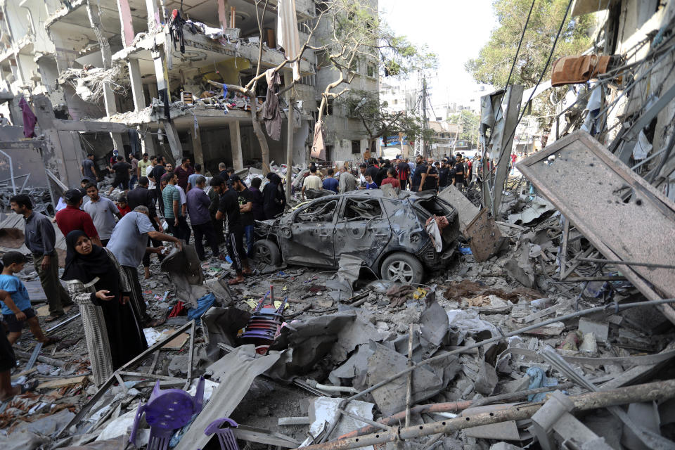 Palestinians inspect the damage of buildings that were hit by Israeli airstrikes, in the Shati refugee camp, Gaza City, Tuesday, Oct. 31, 2023. (AP Photo/Abed Khaled)