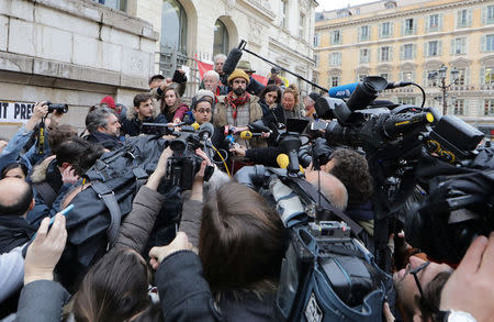 Cedric Herrou (top C), a French farmer and volunteer helping migrants cross French-Italian border to avoid police controls, talks to journalists after he was handed a 3,000 euros ($3,192) suspended fine for his actions at the courthouse in Nice, France, February 10, 2017. REUTERS/Eric Gaillard