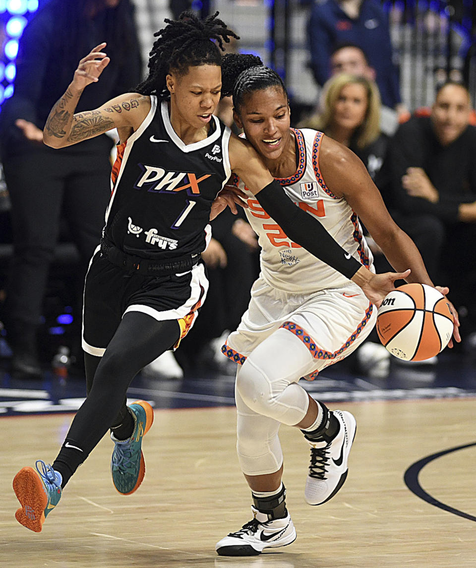 Phoenix Mercury's Sug Sutton (1) steals a ball from Connecticut Sun's Alyssa Thomas (25) during a WNBA basketball game in Uncasville, Conn., Thursday, Aug. 31, 2023. (Sarah Gordon/The Day via AP)