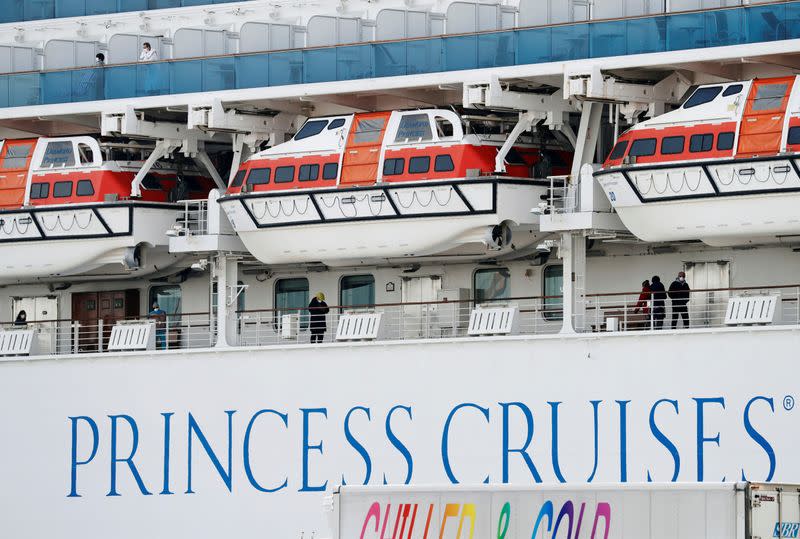 Passengers walk along a deck of the cruise ship Diamond Princess at Daikoku Pier Cruise Terminal in Yokohama, south of Tokyo, Japan