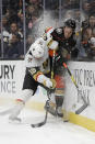 Vegas Golden Knights center Patrick Brown, left, checks Anaheim Ducks defenseman Jacob Larsson during the first period of an NHL hockey game in Anaheim, Calif., Sunday, Feb. 23, 2020. (AP Photo/Chris Carlson)