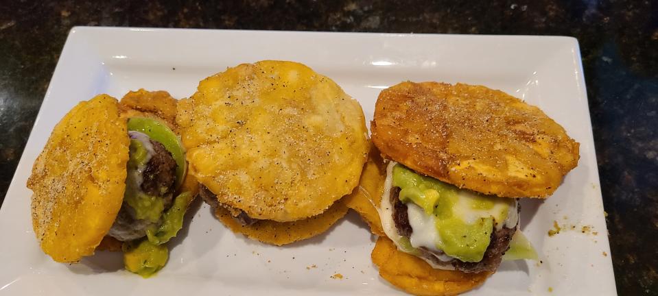 Midnight Tavern's burger sliders are topped with guacamole, provolone and green tomato.
