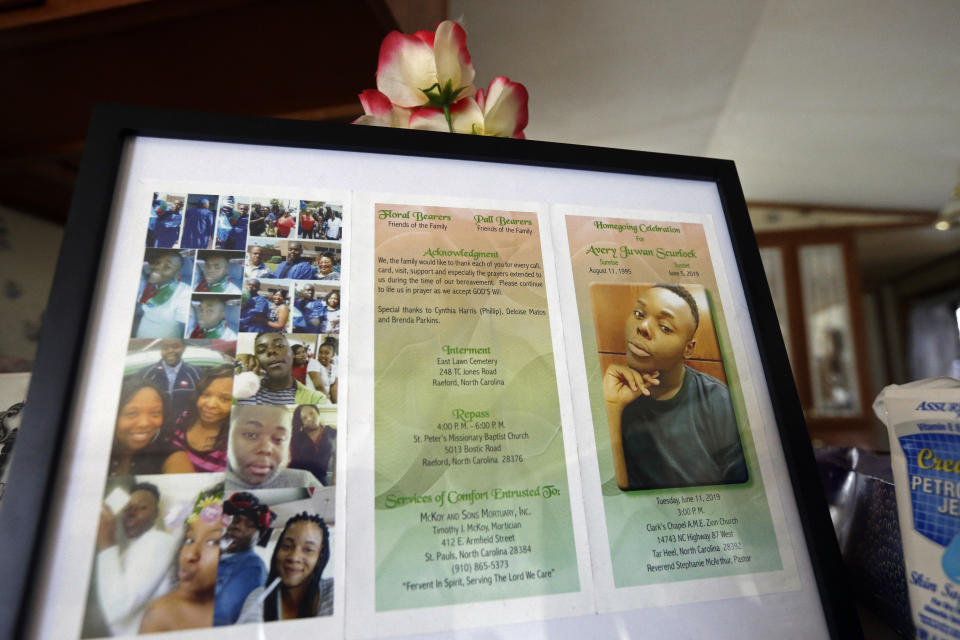 In this photo taken Tuesday, Aug. 6, 2019, a framed copy of Avery Scurlock's memorial is shown in Avery's mother Brenda Scurlock's home in Lumber Bridge, N.C. Avery, who used the name Chanel when dressing as a woman in social settings and hoped to have sex reassignment surgery, was found shot to death in June. This death of a transgender person in North Carolina is one of 18 so far this year, and 17 of the victims have been black women. (AP Photo/Gerry Broome)